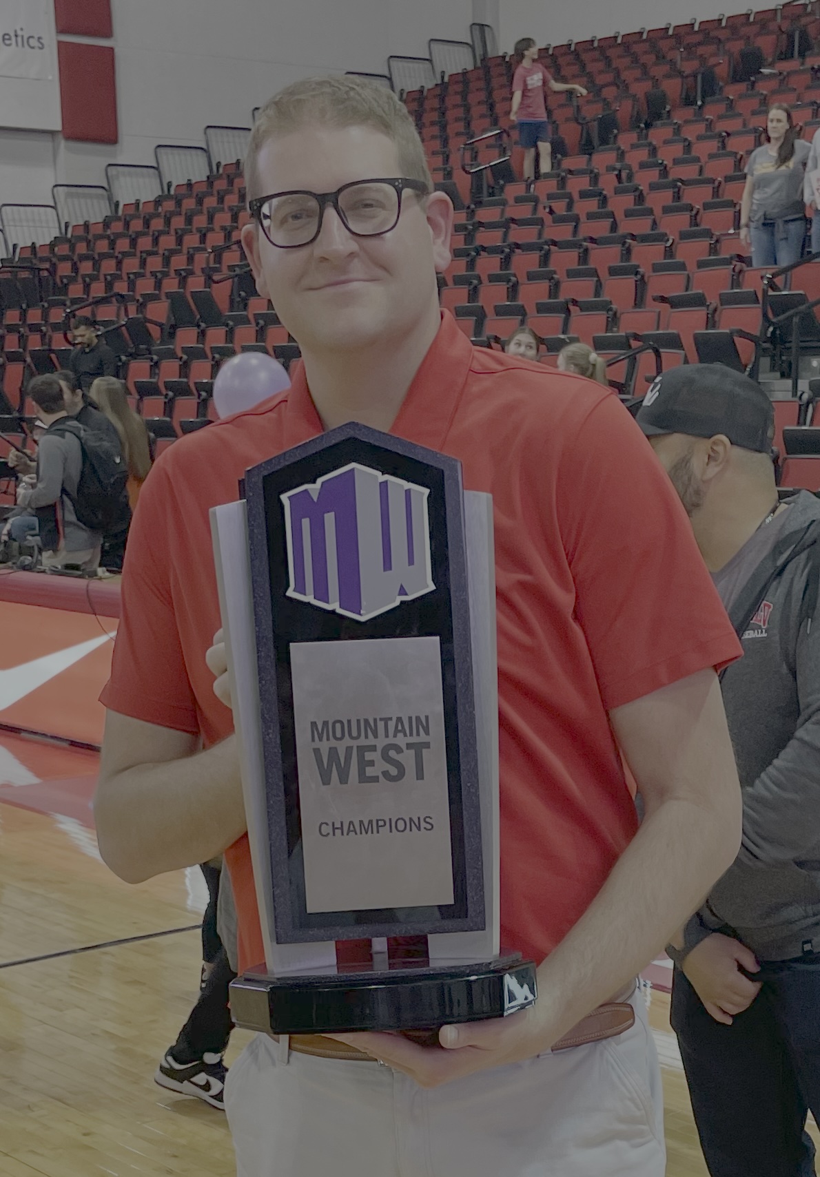 Steve Rindfleisch holding Mountain West Championship trophy
