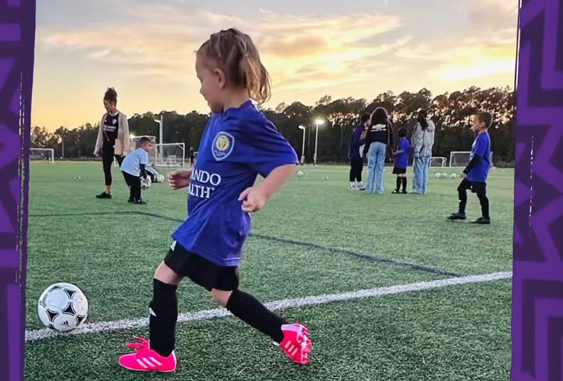 Girl playing recreational soccer